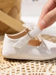 white baby shoes, elegant baby shoes, patent baby shoes, shoes for infants, comfortable baby shoes, high-quality baby shoes, baby shoe size guide