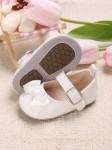 white patent baby shoes, bow-adorned baby shoes, elegant baby shoes, shoes for infants, comfortable baby shoes, high-quality patent shoes, baby shoe size guide