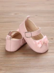 pink patent baby shoes, bow-adorned baby shoes, elegant baby shoes, shoes for infants, comfortable baby shoes, high-quality patent shoes, baby shoe size guide
