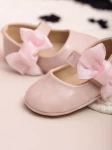 pink baby shoes, bow-adorned baby shoes, elegant baby shoes, shoes for infants, comfortable baby shoes, high-quality patent shoes, baby shoe size guide