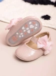 pink baby shoes, bow-adorned baby shoes, elegant baby shoes, shoes for infants, comfortable baby shoes, high-quality patent shoes, baby shoe size guide