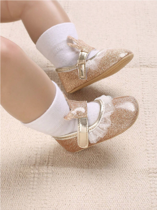 Golden baby shoes, baby footwear, crown adorned shoes, first step shoes, soft sole baby shoes, baby shoe sizes, elegant baby shoes, baby shoe design, baby shoe material