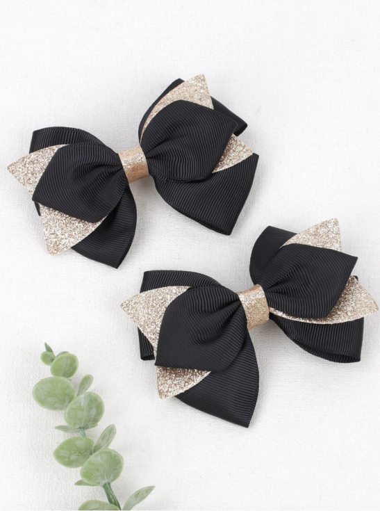 Elegant hair clips, black bow clips, girls' accessories Ireland, stylish hair accessories, hair clips for sensitive skin, hair clips for girls, versatile hair clips, black and gold clips, high-quality hair clips, children's fashion accessories