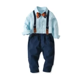 Boy in sky-blue Christian shirt with amber bow tie at Irish wedding