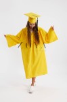 Vibrant sunshine yellow graduation gown on young scholar at Irish ceremony