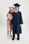 Child in navy graduation set smiling at Galway event – perfect fit for ages 6–12