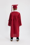 Child in crimson graduation gown accepting certificate on stage