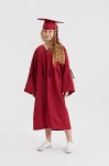 Family embracing graduate in crimson ensemble