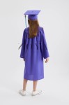 Young child in royal heliotrope graduation gown at nursery ceremony