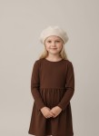 Kids beige beret with pom pom in Parisian style close up