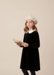 Girl wearing beige beret with pom pom on autumn walk