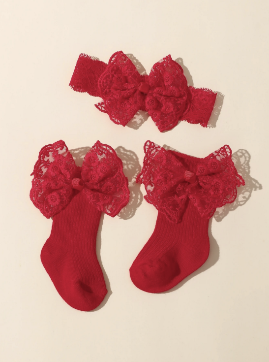 Baby girl red lace socks and bow headband set styled with winter dress