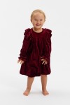Close up of velour fabric and shoulder ruffles in rich burgundy