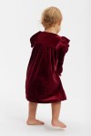 Toddler in burgundy occasion dress twirling knee length skirt