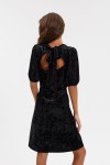 Back view of Clara black velvet dress showing open back and bow tie