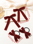 Girl wearing burgundy velvet bow clip in high ponytail, natural light