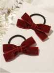 Close-up of large burgundy velvet bow clip with soft pile finish