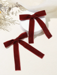 Flat-lay of two bow clips and two bow hair ties, rich burgundy