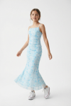 Girl wearing Fiorella blue floral maxi dress in soft daylight