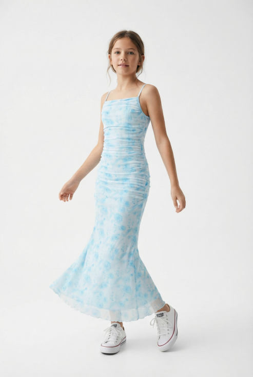 Girl wearing Fiorella blue floral maxi dress in soft daylight