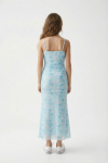 Girl wearing Fiorella blue floral maxi dress in soft daylight
