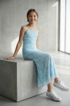 Girl wearing Fiorella blue floral maxi dress in soft daylight