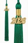 Primary school pupil wearing green mortarboard with tassel draped neatly for Sixth Class photos
