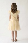 Girl styled in Paola butter-yellow tulle dress for First Holy Communion