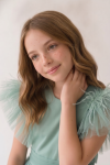 Girl styled in the mint green Paola tulle dress for a special occasion