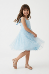 Close-up of glitter application tulle on light blue girls dress