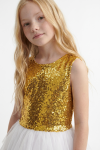 Riva white and gold dress for girls – close-up of the gold sequin top with round neckline, waist-up shot