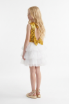 Riva white and gold dress for girls – angled back view: cut-out, sequin bow at the waist and layers of tulle