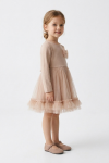 Iga beige tulle dress for girls with a bow on the chest – three-quarter front view