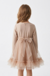Iga beige dress for girls – back view with the zip and the tulle sash tied in a big bow at the waist