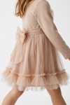 Iga beige dress for girls – tulle sash tied in a bow at the back and ruffles at the hem, side view