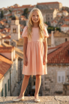 Sia pink party dress for girls – full-length front view against an old town backdrop