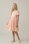 Sia pink knee-length party dress for girls – full-length front view, studio background