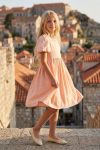 Sia pink party dress for girls – side view against old town rooftops