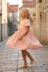 Sia pink party dress for girls – twirling on a cobbled old town lane