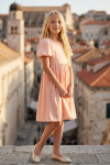 Sia pink party dress for girls – full-length shot in front of an old town tower