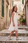 Rozalia white pleated dress for girls outdoors on steps – side view