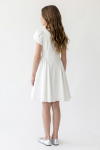 Rumi white dress for girls – back with the pointed waist seam and gathered skirt, back view