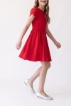Rumi red dress for girls – flared skirt in motion, shot down to the feet