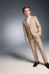 Liam beige suit for boys – buttoned blazer and trousers, hand in pocket, three-quarter view