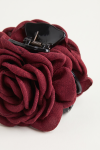 Burgundy fabric rose on a black claw clip for girls – close-up