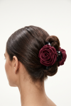 Burgundy flower claw clip for girls holding a bun – back view