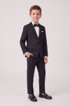 Sam black suit for boys with blazer, trousers and bow tie – boy facing the camera, full length